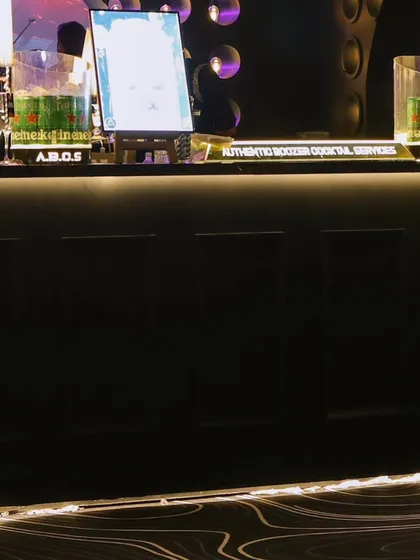 The bar in action, fully stocked and ready to serve, with custom branding and elegant table lamps.
