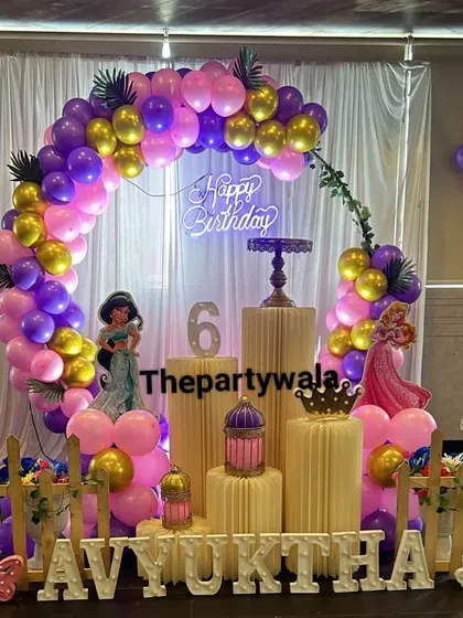 For a truly royal celebration, my Princess theme is always a favorite. This setup for a 6th birthday features a beautiful balloon arch in purple and pink, cutouts of famous princesses like Jasmine and Aurora, and elegant gold accents.