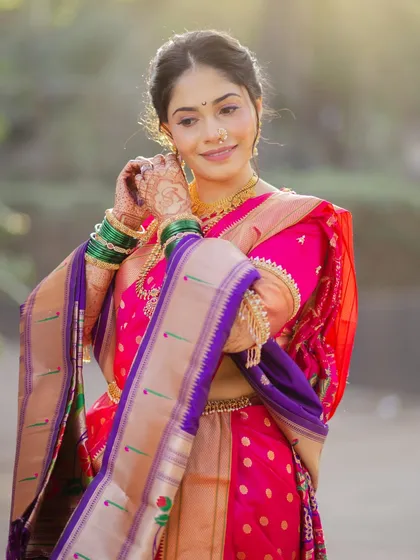 The elegance of a Nauvari saree. This shot captures the beautiful drape and the bride's graceful posture, highlighting the traditional Maharashtrian silhouette.