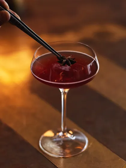 The final touch on our Pickled Pom Whiskey. A star anise garnish adds a subtle aromatic layer to this bold, bourbon-based signature cocktail.