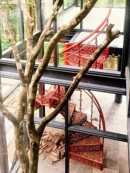 A detail from our Yercaud villa, where a vibrant red spiral staircase becomes the centerpiece. We love incorporating unique, artistic elements that are not only functional but also add a strong character and a memorable focal point to the space.