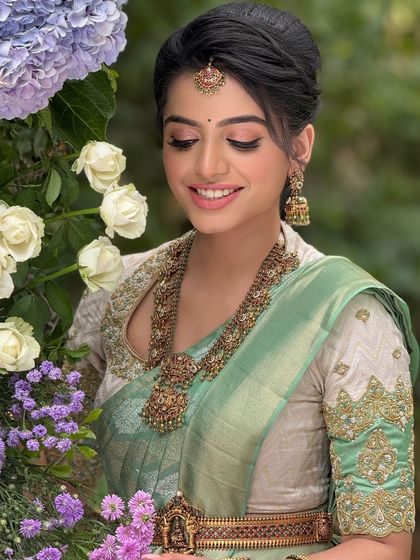 An eyes-closed portrait of the bride, focusing on the soft, blended eyeshadow and the radiant finish of her skin.