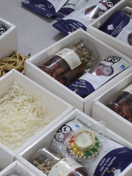 A closer look at one of our corporate gift boxes being assembled. Each one is packed with a variety of our healthy snacks and treats, perfect for showing your employees you care.