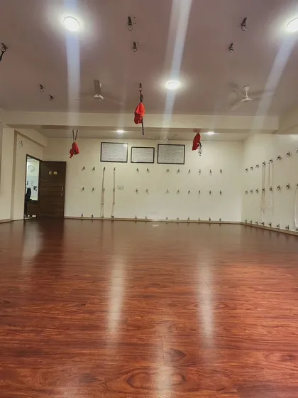 This is our main practice hall, Studio 1 - Manipura. We designed this space to be a sanctuary, with natural light, grounding wooden floors, and a full set of props to help you safely explore, align, and deepen your practice.