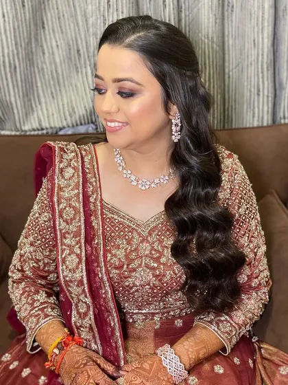 The bride looking serene and beautiful. Her makeup is perfectly blended, creating a flawless finish that lasts all night.