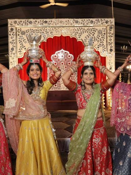 A beautiful moment from a Mayra ceremony, with the women of the family celebrating in our custom-designed lehengas. We created a unique color story for each person, from bright yellow to festive red, to reflect their individual personalities.