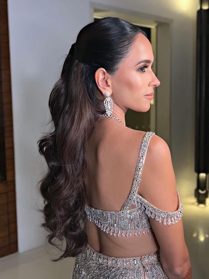 A side profile of the glamorous half-ponytail, showing its volume and elegant shape.