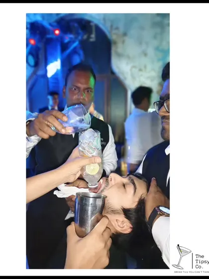 A fun and slightly wild moment where our bartenders help a guest take a 'long shot'. It's all about creating a high-energy, unforgettable party atmosphere.