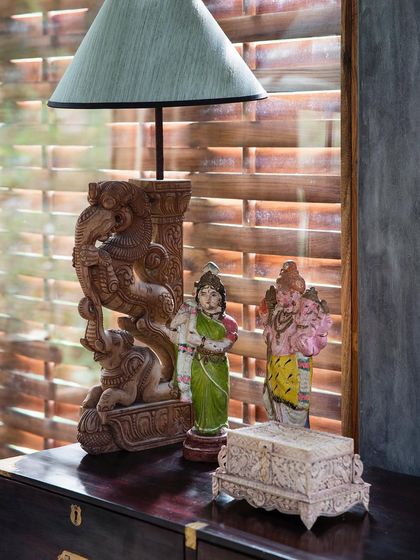 Hand-carved wooden figures and other collected objects add a layer of Indian heritage and artistry to the interiors. These details make each space feel unique and deeply rooted in our culture.