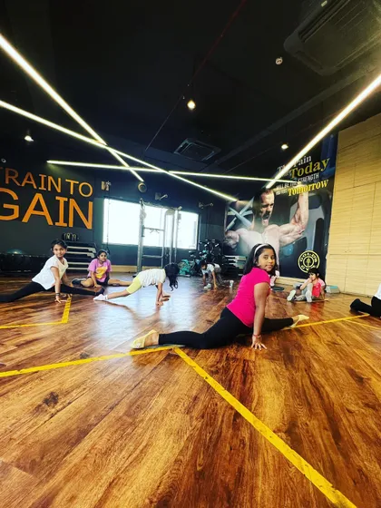 A young dancer proudly holding her split. We create a supportive environment where every small victory in flexibility and strength is celebrated by the whole class.
