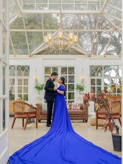 A dramatic shot with a long trail gown. The makeup is glamorous and designed to make a statement, just like the stunning outfit.