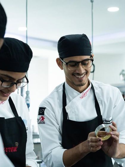 A chef guiding students through a new technique. Our instructors are always there to help and ensure everyone understands the process.
