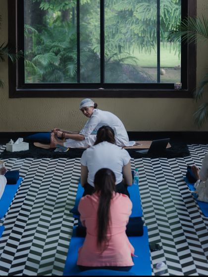 A view from the back of our class, showing the shared focus and dedication of the Sangat. I often provide gentle adjustments to help students deepen their practice safely.