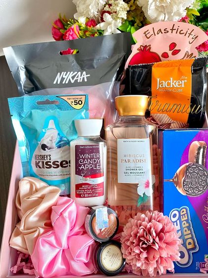 A lovely customized birthday hamper for her, including Bath & Body Works shower gel, a Kama face mask, a Body Shop lip balm, and a variety of chocolates and wafers.