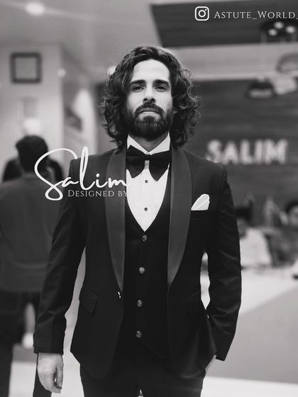 A client looking sharp in a classic black three-piece tuxedo. This is the epitome of timeless formal wear, tailored for a perfect fit.