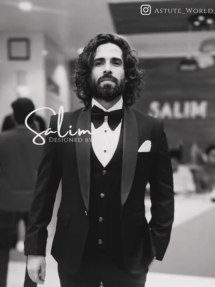 A client looking sharp in a classic black three-piece tuxedo. This is the epitome of timeless formal wear, tailored for a perfect fit.