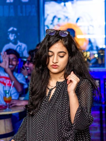 A guest in her own world, feeling the beat. The dance floor is a place for personal expression.