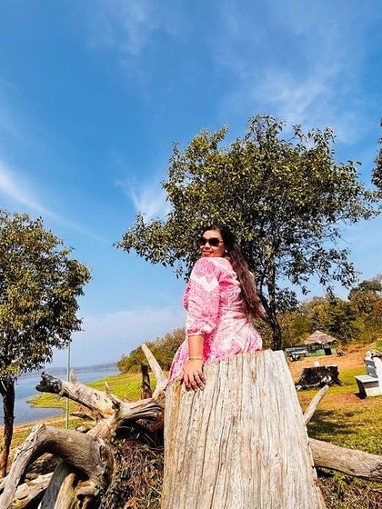 A traveler posing by the water's edge in Coorg. Our trips offer plenty of opportunities for beautiful solo shots in nature.