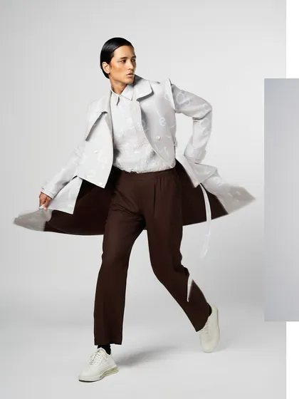 Another dynamic shot for Line Outline, showcasing a clean yet strong grooming look. The focus is on defined features and flawless skin to complement the avant-garde clothing.