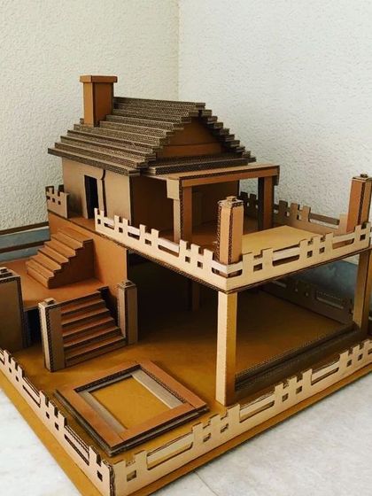 This detailed, multi-level dollhouse is another example of my interactive builds. Made from corrugated cardboard, it features stairs, a balcony, and a chimney, providing a sturdy structure for kids to decorate and play with.