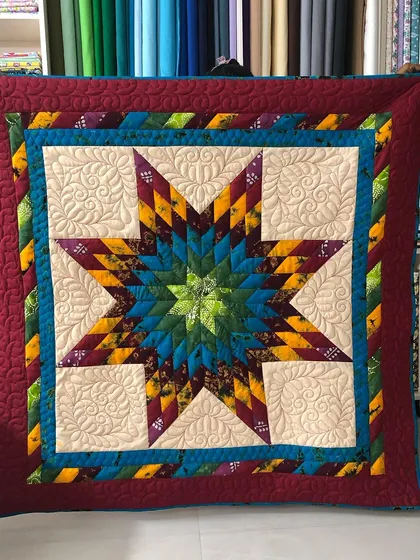 A vibrant Glowing Star quilt with a beautiful gradient of colors.
