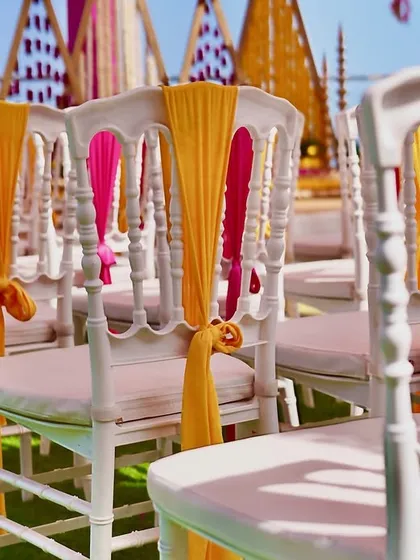 Detail of the chair decor, showing how simple fabric ties can add a pop of color and elegance to the guest seating.