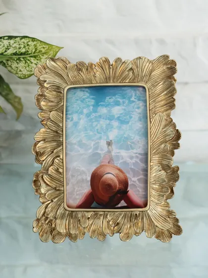 Our golden frame with a flowing, feather-like texture. This elegant and artistic piece is perfect for framing a serene vacation photo, adding a touch of sophisticated glamour.
