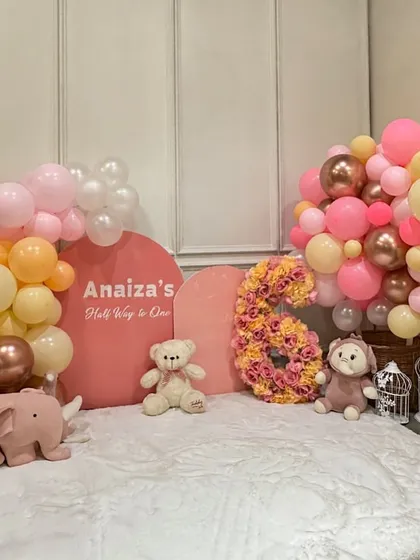 Celebrating "Half Way to One" is such a special milestone. We designed this adorable pink and peach themed setup for a 6-month birthday, complete with a floral number '6' and cute stuffed animals.