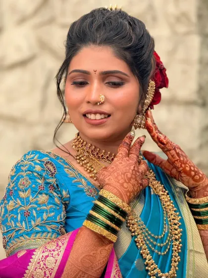 An unedited DSLR click of my stunning bride Ankita. Her look features a beautiful blue and pink saree, complemented by gold jewellery and a floral bun.