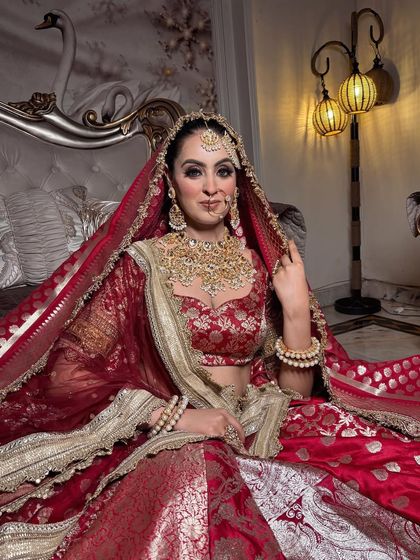 Another angle of this royal bridal look. The heavy jewellery and the deep red banarasi lehenga are perfectly balanced with a classic makeup style.