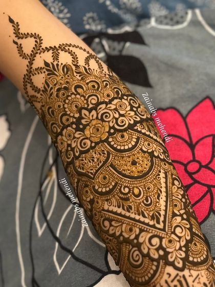 A close-up of the intricate patterns on Afrah's arm, showcasing the beautiful swirls and floral motifs.