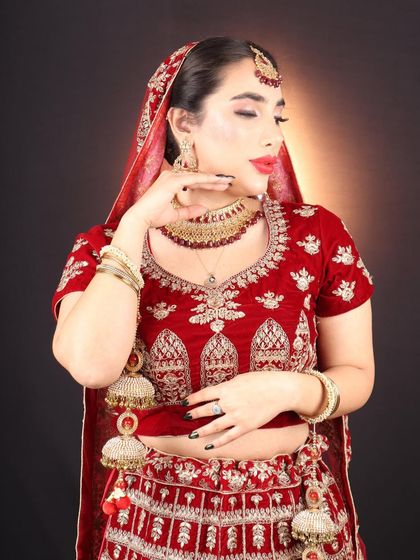 A final look at this stunning international bride. The combination of the red lehenga, gold jewellery, and classic makeup created a timeless and unforgettable look.