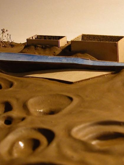 The model illustrates the concept of a new, clean plane (represented by the blue element) being superimposed over the damaged earth, symbolizing a path toward healing and recuperation.