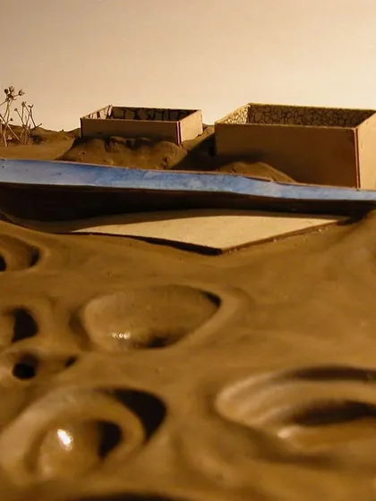 The model illustrates the concept of a new, clean plane (represented by the blue element) being superimposed over the damaged earth, symbolizing a path toward healing and recuperation.