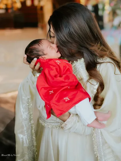 A mother's gentle kiss for her newborn son. This is a memory of pure, unconditional love.