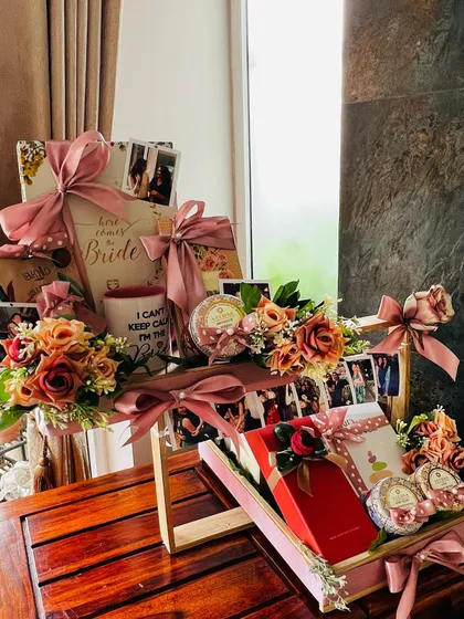 This shot captures the full scale of the bespoke bridal hamper. It shows how multiple elements, from photo displays and floral arrangements to individually wrapped gifts, come together to create a grand and impressive statement piece.