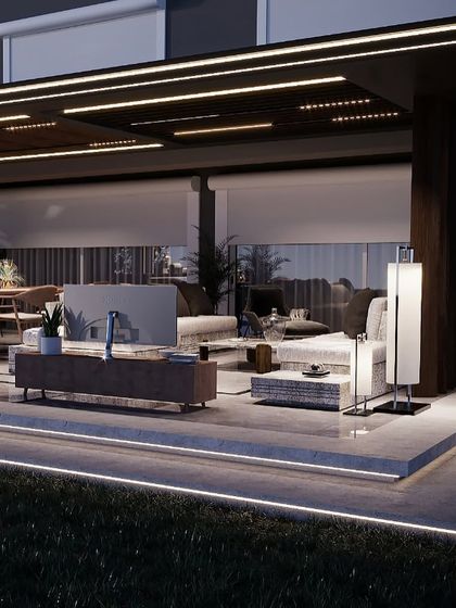 This view highlights the layered lighting design of the backyard project, with LED strips along the platform edge, recessed ceiling lights, and accent sconces. This creates a warm, inviting glow throughout the entire outdoor living space.