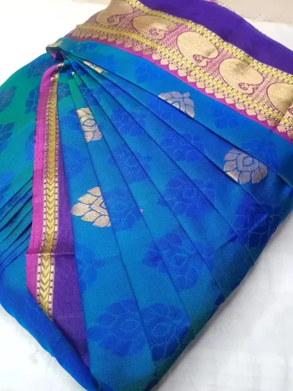A beautiful blue and purple silk saree, pleated and box-folded.