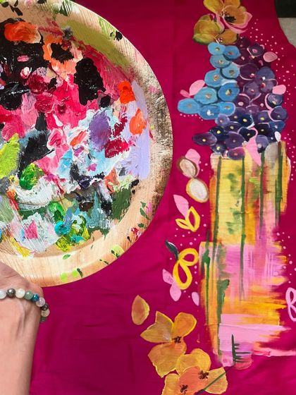 A glimpse of my messy, colorful paint palette next to a vibrant abstract piece I was working on. This is where the magic begins.