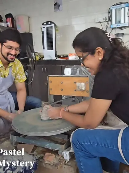 Laughter and learning go hand in hand at the studio. This couple shares a happy moment at the pottery wheel, enjoying the process of learning a new skill together.