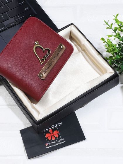 A beautiful maroon leather wallet personalized with a hanging heart 'Love' charm, perfect for a romantic gift.