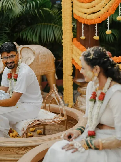 A candid moment of pure joy during Ketaki and Rakesh's Haldi. Surrounded by friends and family, the couple shares a laugh as they are showered with blessings and flower petals.