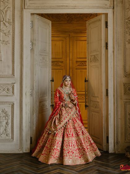 A majestic full-length view that captures the grandeur of the bride on her wedding day. The makeup stands out, yet harmonizes perfectly with the intricate details of her Rimple and Harpreet lehenga.