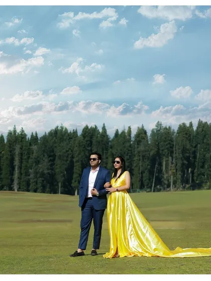 A stylish pose against the backdrop of Kashmir's endless pine forests and a dramatic sky. This shot showcases how we can create a high-fashion look even in the midst of nature, blending elegance with the raw beauty of the mountains.