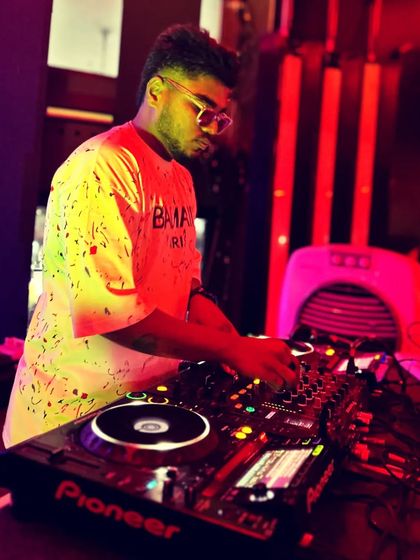 A clear shot of me at the DJ console, surrounded by the warm red lights of the club. This is my office, and I love what I do.