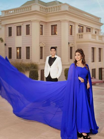 Another grand shot from the anniversary shoot, showcasing the stunning blue gown and the flawless makeup that completes the look.