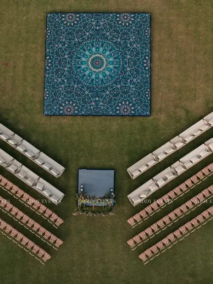 An aerial detail of the guest seating and dance floor. The symmetrical arrangement of chairs and the striking mandala-print dance floor showcase our eye for aesthetic balance and detail.