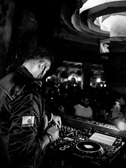 A black and white shot from behind the console at Baglami. The architecture of the club and the packed floor create a stunning composition.