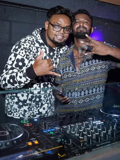 With an MC at a "Major Flava Friday" event. I can arrange for an MC to host your party, engage the crowd, and take your event to the next level.