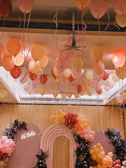The warm glow of the room and the floating balloons create such a dreamy atmosphere. This baby shower was designed to feel like you're walking into a warm, happy cloud.